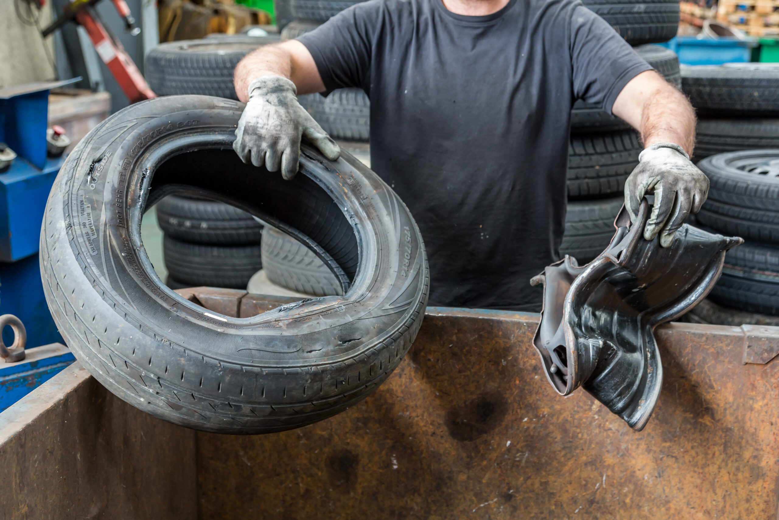 Mechanic removing rim from old car tire