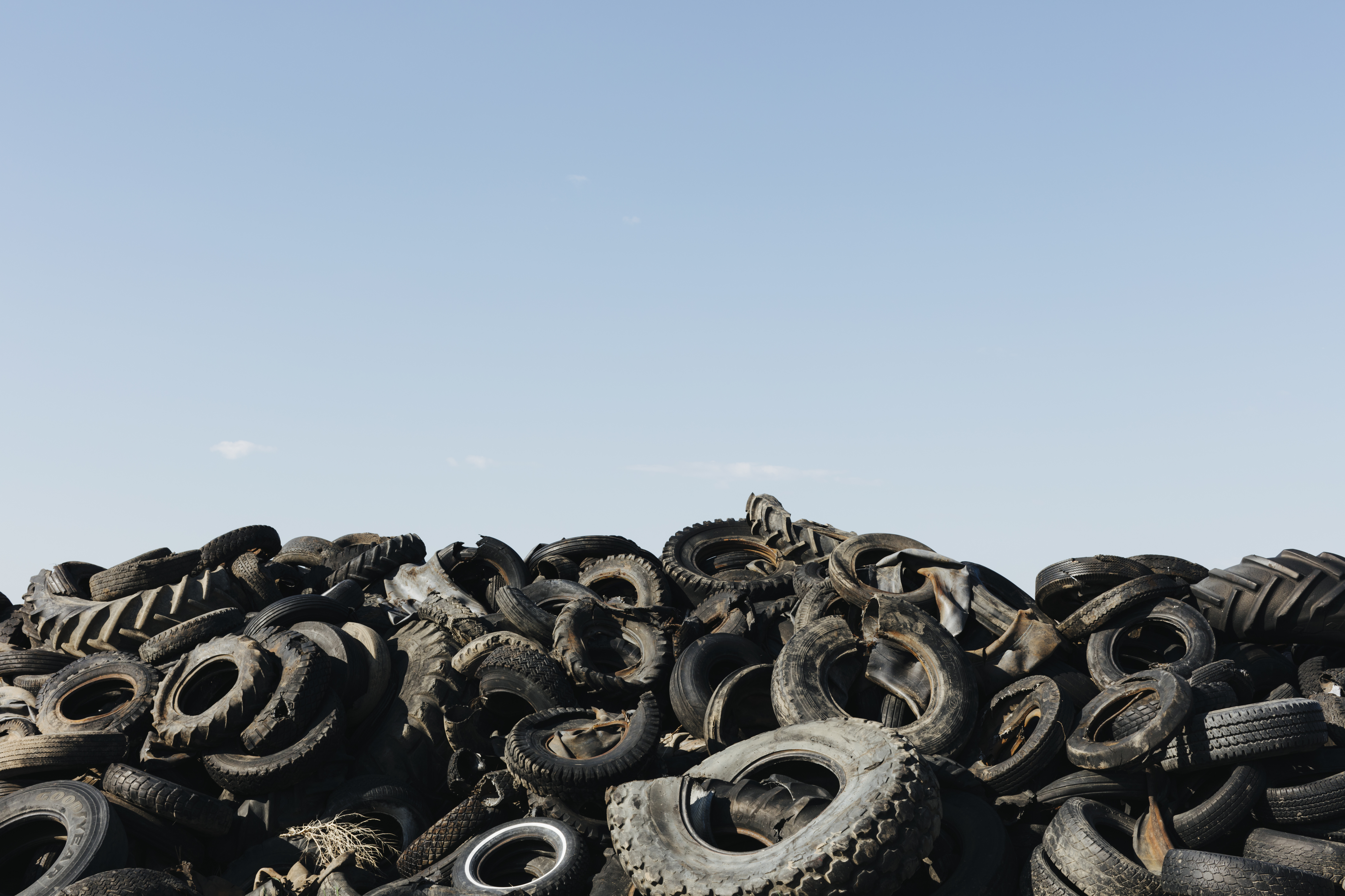 Pile of discarded auto and tractor tires in rural landfill, abandonned farms